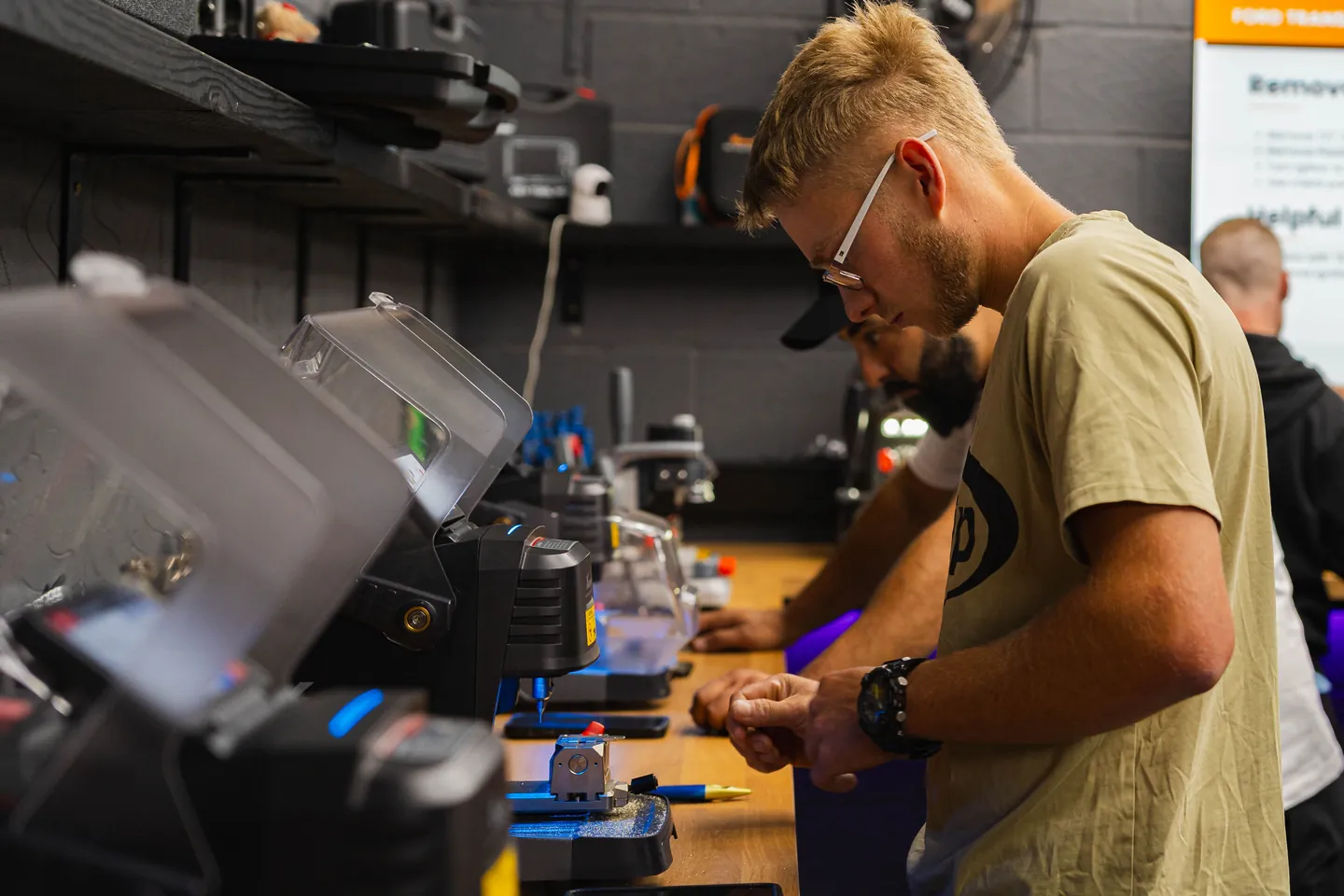 Two students work on the key cutting machines