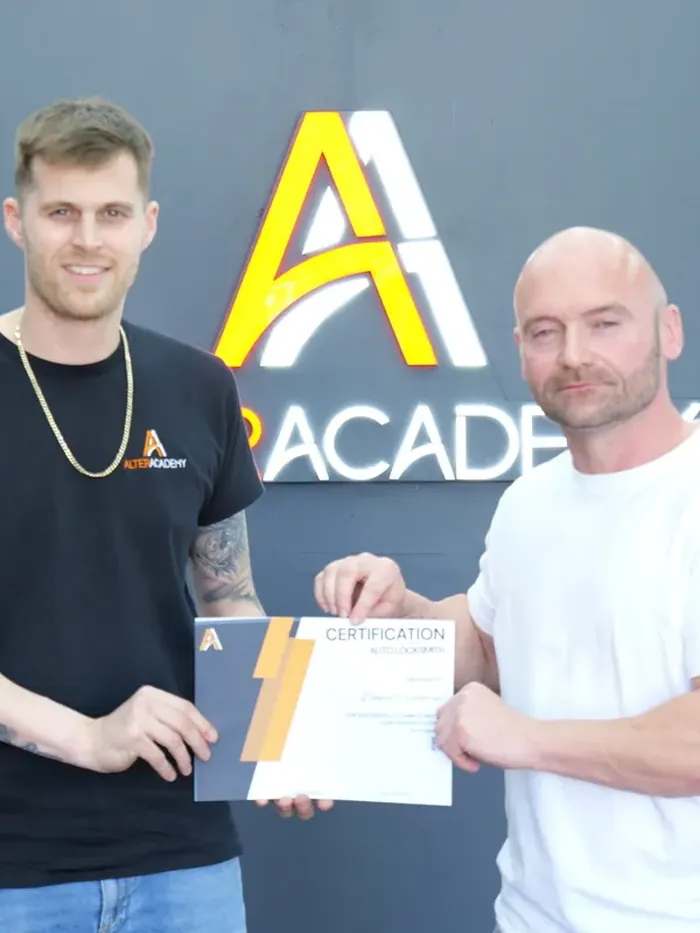 A trainer presents a student with his course certificate