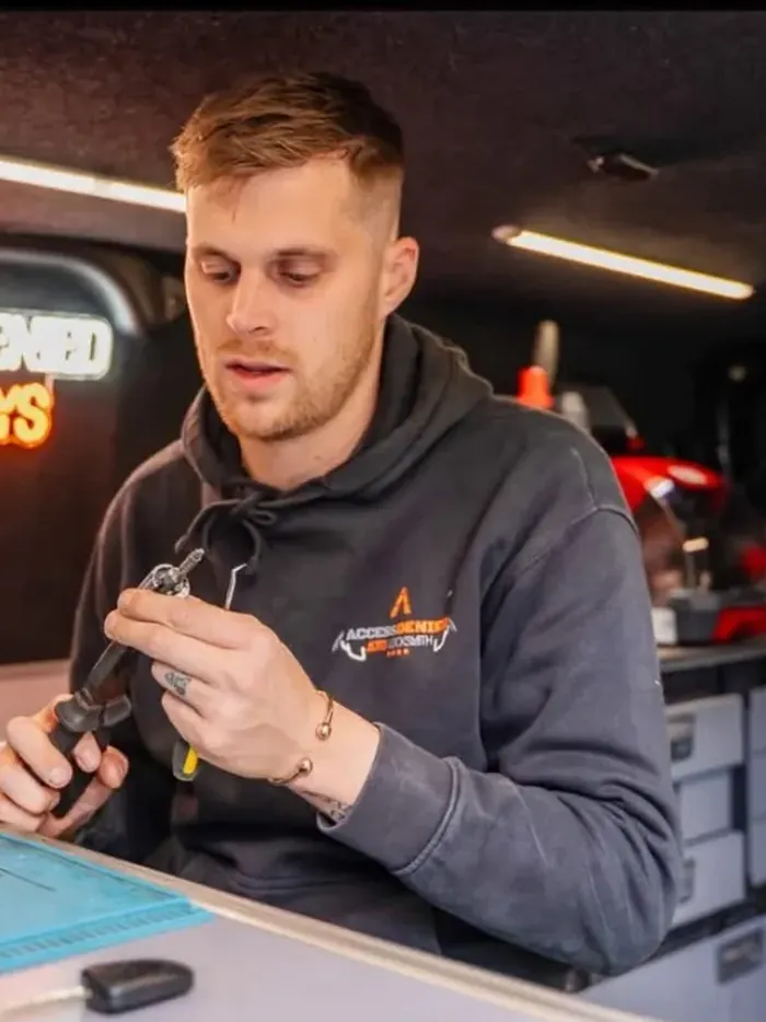 Tyler Steadman in his van at the key programming bench